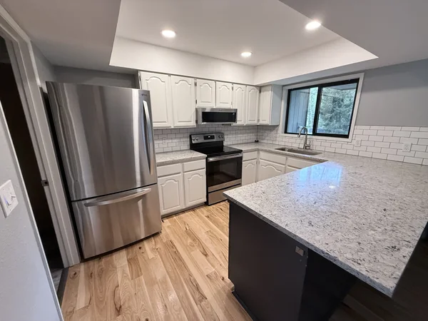 Kitchen counters, appliance fronts, and floor cleaned