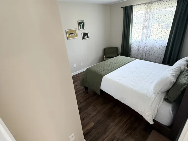 Bedroom cleaned with floors and surfaces reset