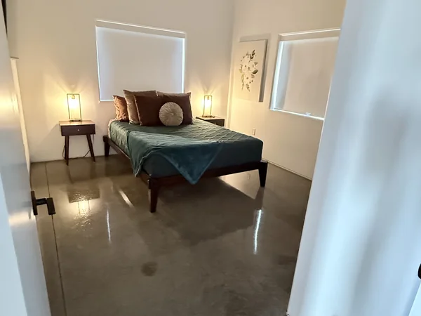 Bedroom cleaned with bed, floors, and visible surfaces reset