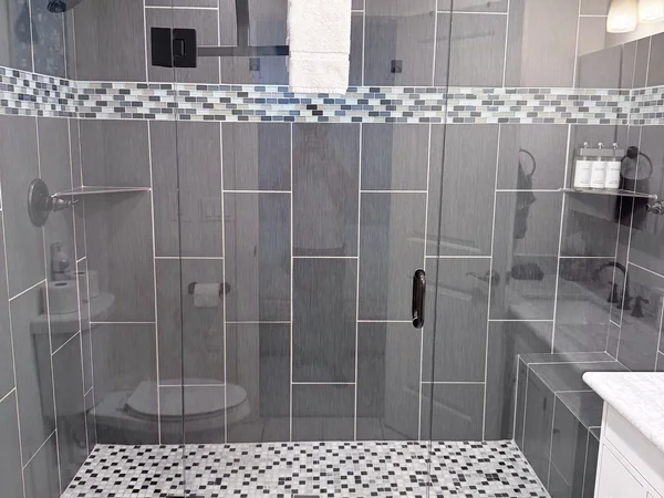 Tile shower cleaned with glass and surrounding surfaces reset